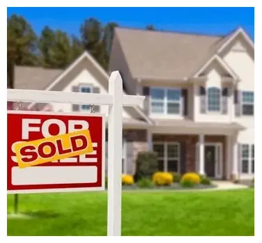 A house with a for sale sign in front of it