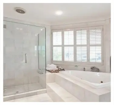 A bathroom with a large tub and shower.