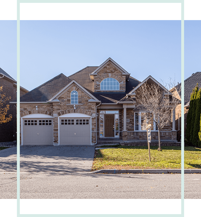 A house with three garage doors and two windows.